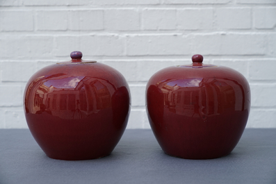 A pair of Chinese monochrome oxblood-glazed jars and covers, 19th C.